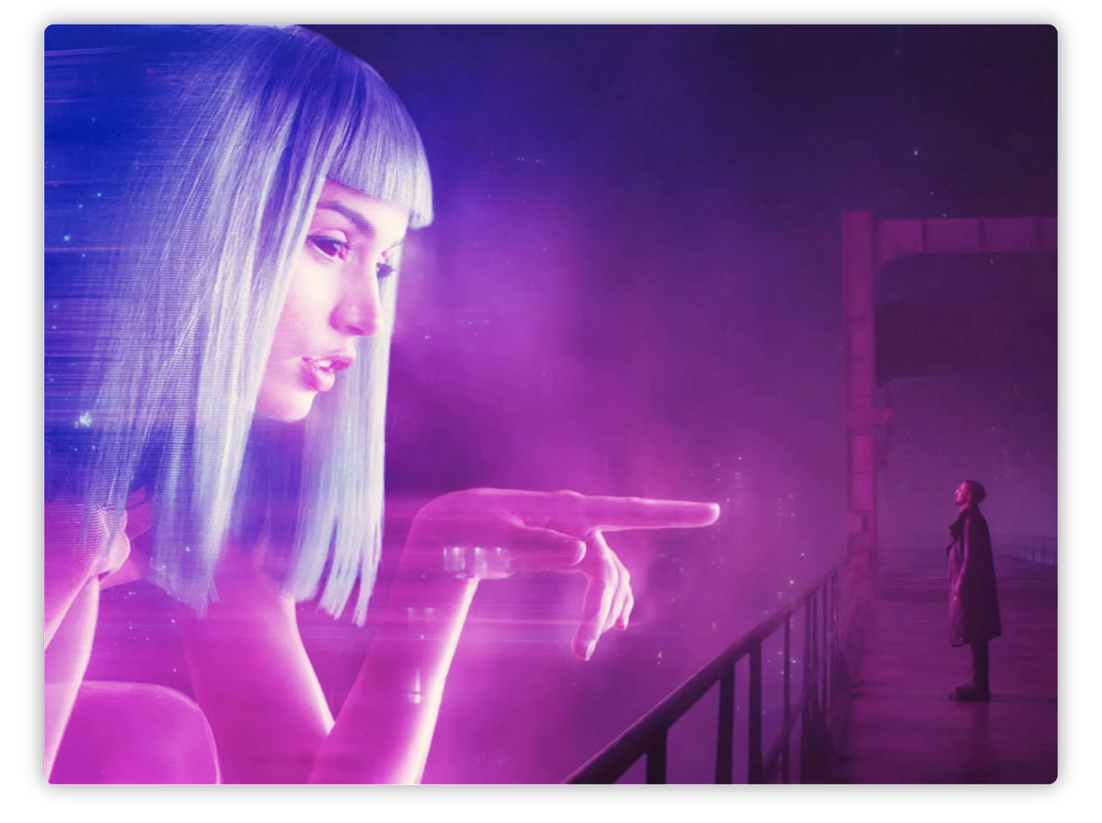 Imagen futurista de tonos morados y rosados que muestra una figura femenina gigante y holográfica con cabello azul y flequillo, mirando hacia abajo y señalando hacia un hombre que se encuentra de pie en una pasarela. La mujer tiene una expresión serena y parece estar interactuando con el hombre, quien la observa desde una distancia. La escena tiene una atmósfera tecnológica y distópica, destacando el contraste entre el personaje holográfico y el entorno urbano oscuro. La imagen evoca temas de interacción humano-tecnología en un contexto de ciencia ficción.